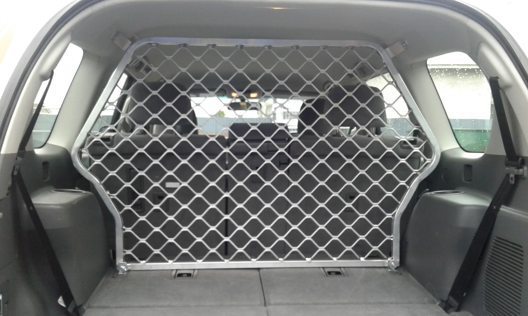 Custom metal cargo barrier fitted inside a vehicle